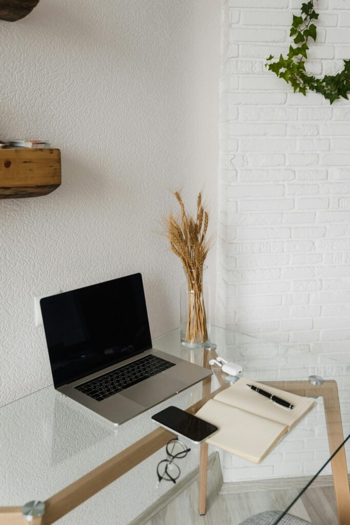 Modern workspace setup with a laptop and smartphone on a minimalist desk.